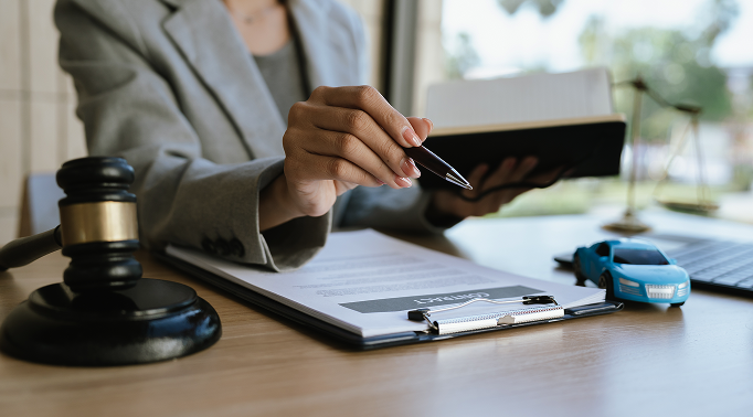 Attorney reviewing a car accident compensation claim with documents and a gavel in Las Vegas